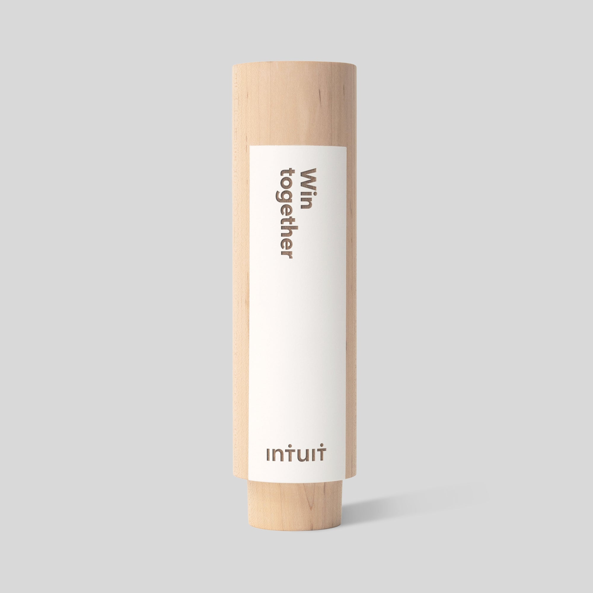 Geometria Award Circulus, a wooden cylinder with a white engraved color field nameplate, showcasing its minimalist design and fine craftsmanship, perfect for honoring employee achievements or as value awards. Architect-designed and artisan-crafted in USA.