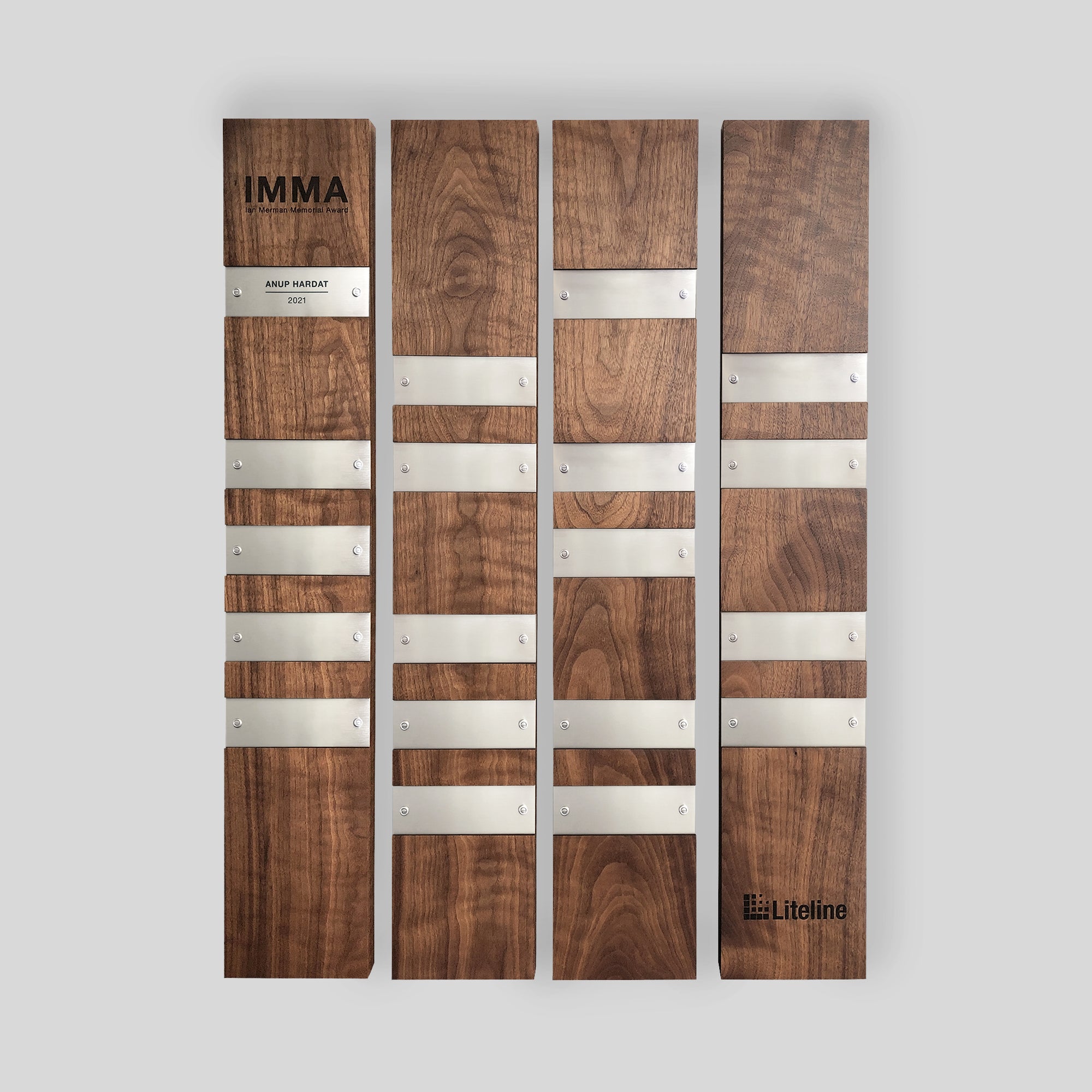 Perpetual Plaques | Walnut: A set of wood plaque modules with silver metal nameplates, designed for engraving and personalization on wood and metal, featuring stainless steel fasteners for periodic updates to the honoree nameplates.