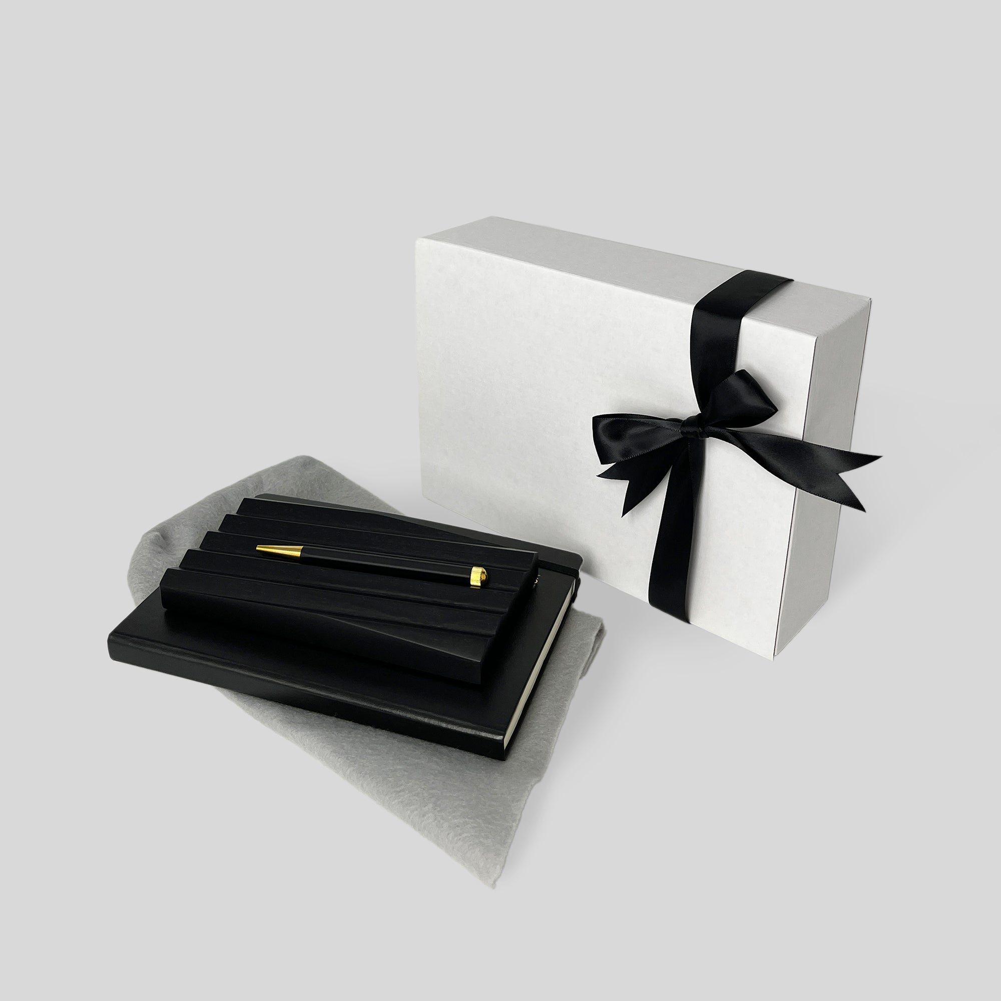 Business Gift Set: Thinking by Hand features a white box with black ribbon and a sleek black pen, embodying elegance and thoughtful design for business gifts.