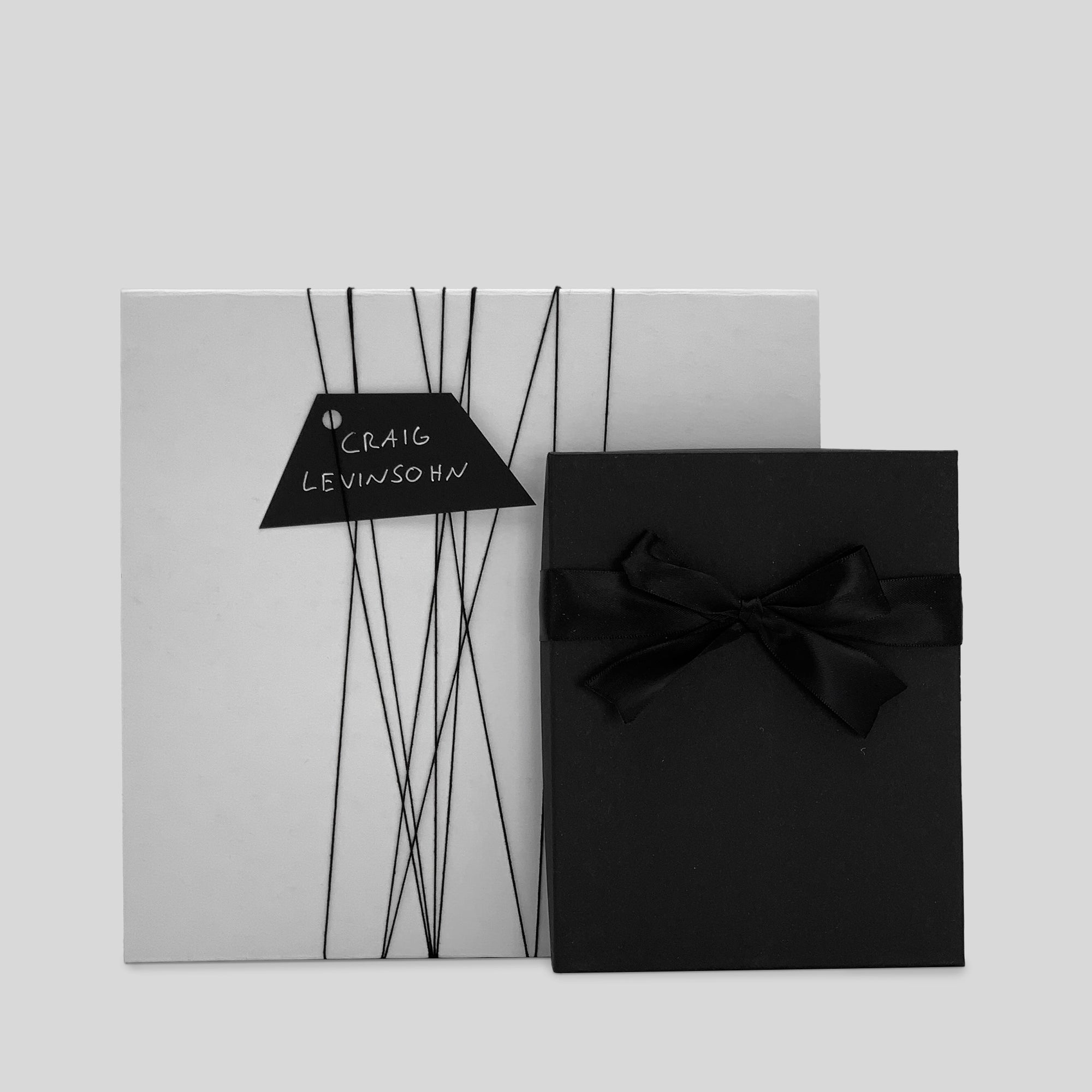 Business Gift Set: Thinking by Hand featuring a black box with a bow, showcasing elegant design and customizable options for a personalized touch for corporate gifting.