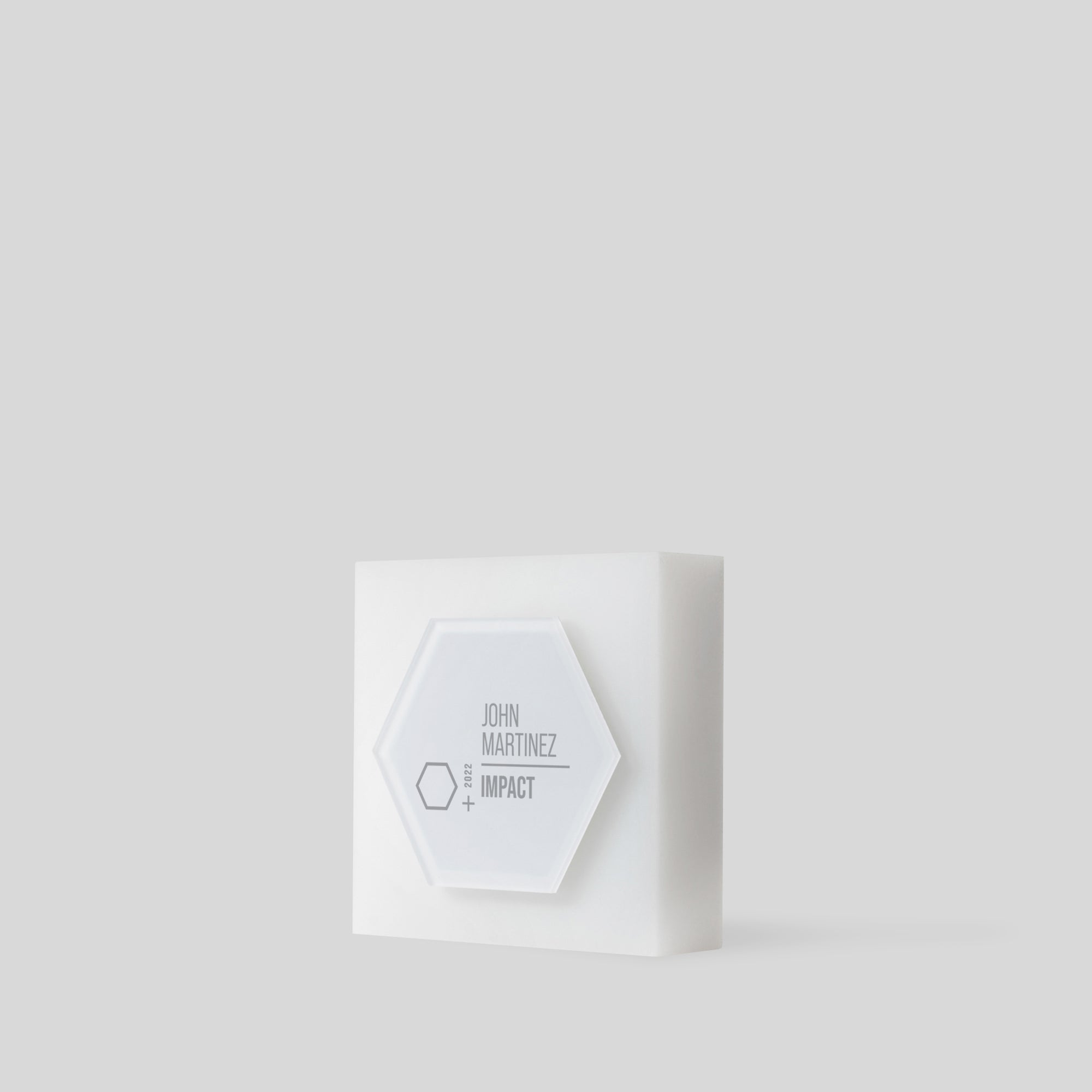 Modern acrylic trophy Glacio Award Hexagon: A frosted hexagon-shaped award on a square base, symbolizing collaboration and excellence, with customizable surface for personalization.