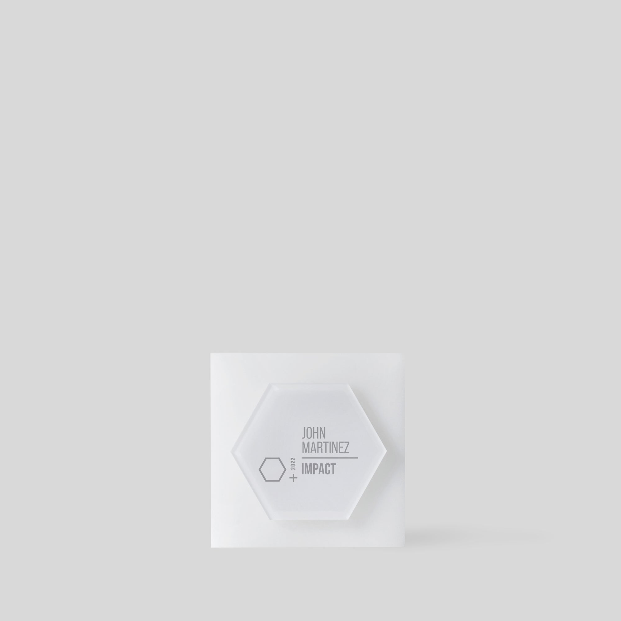 Glacio Award Hexagon, featuring a frosted acrylic hexagonal design on a square base, symbolizes teamwork and excellence with its minimalist, artisan-crafted elegance. Made in the USA. 