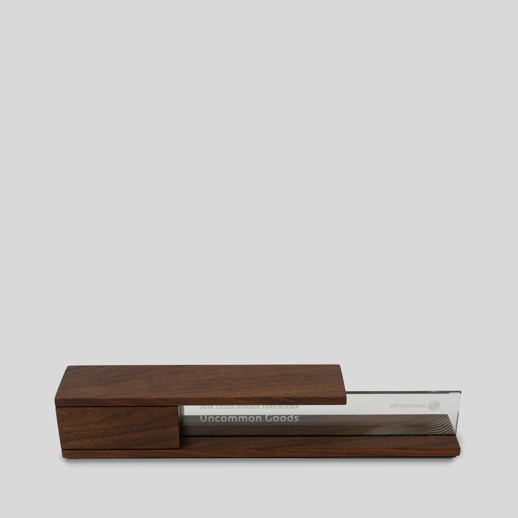 Portico Award: A wooden award featuring engraving on glass, symbolizing architectural beauty and balance, architect-designed and artisan-crafted, elegant, modern meaningful recognition for executives. 