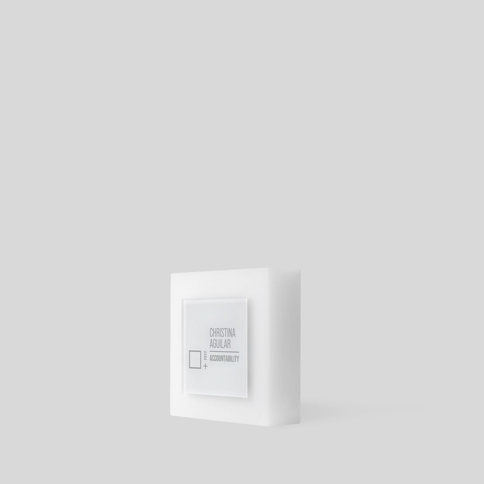 Glacio Award Square: A white square-shaped modern acrylic award with a sleek, frosted finish, featuring a substantial base and customizable surface for personalized recognition. Made in the USA, ideal for employee recognition and team trophies. 